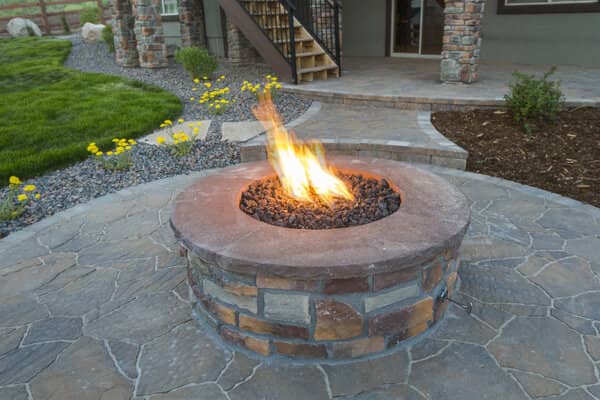 Built in gas stone fire pit with stone paver pation