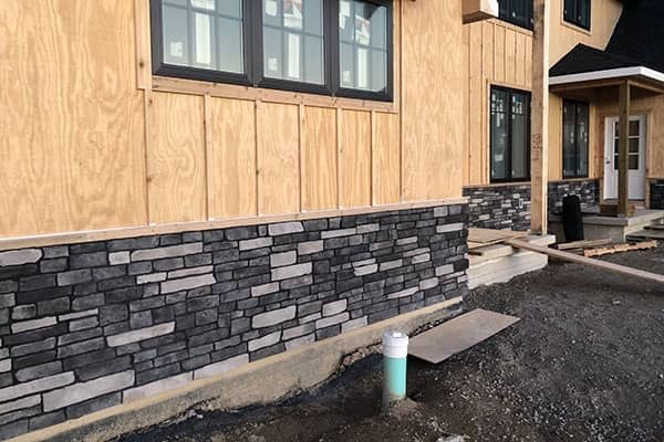 Shaker style new home with gray masonry exterior