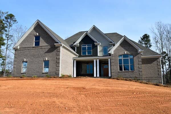 New home construction with gray brick masonry exterior