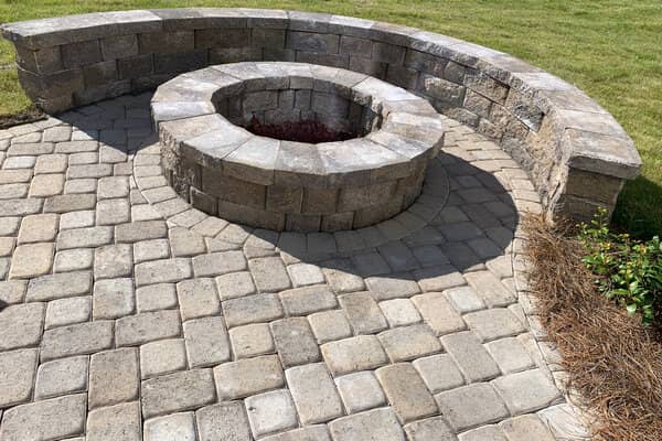 Light gray stone paver patio with fire pit